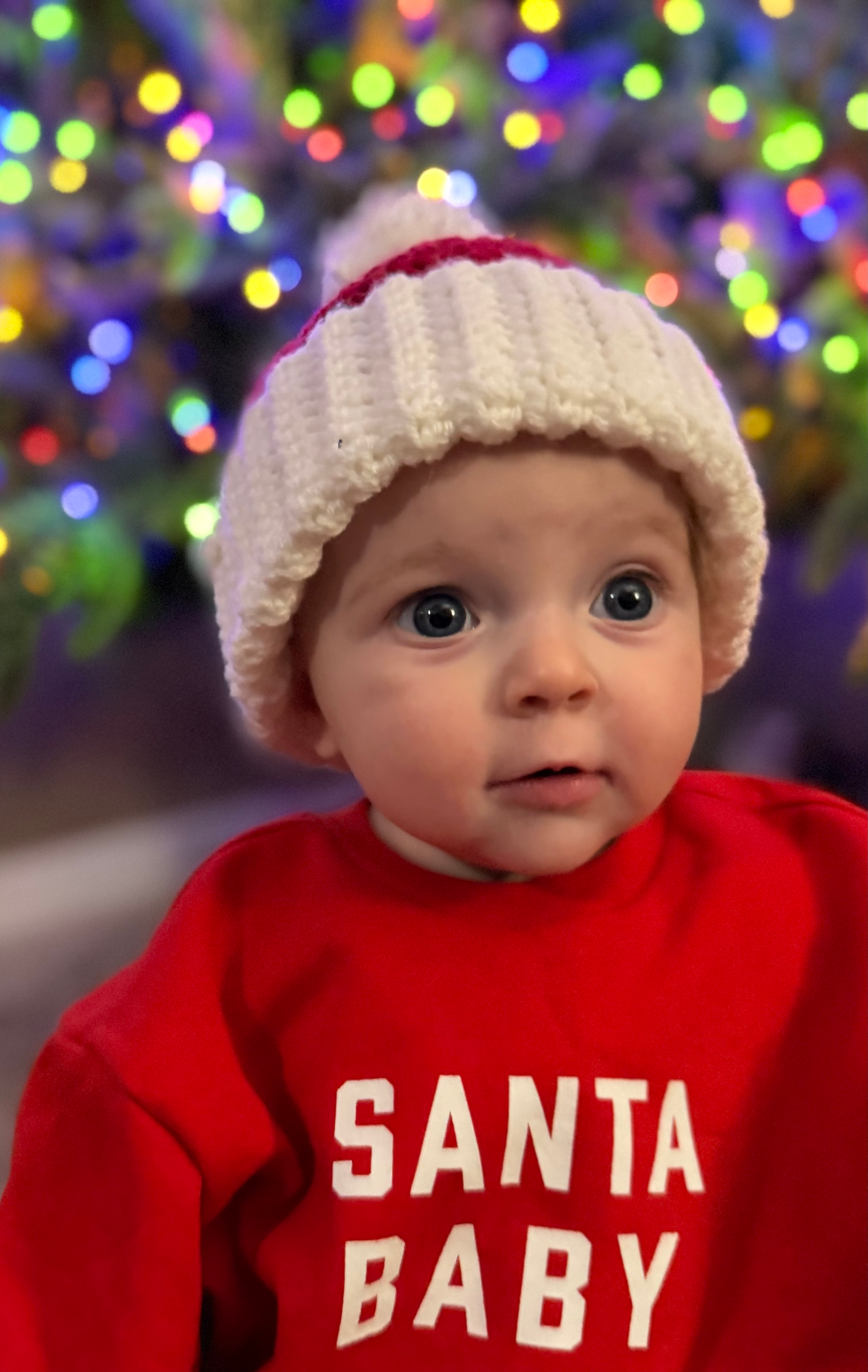 Baby wearing santa hat front view